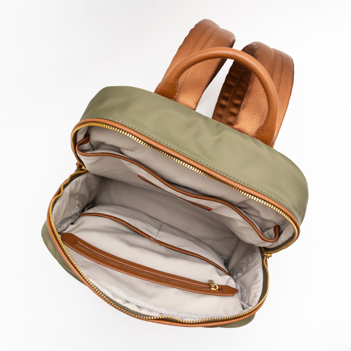 Open green backpack with brown straps on a white background