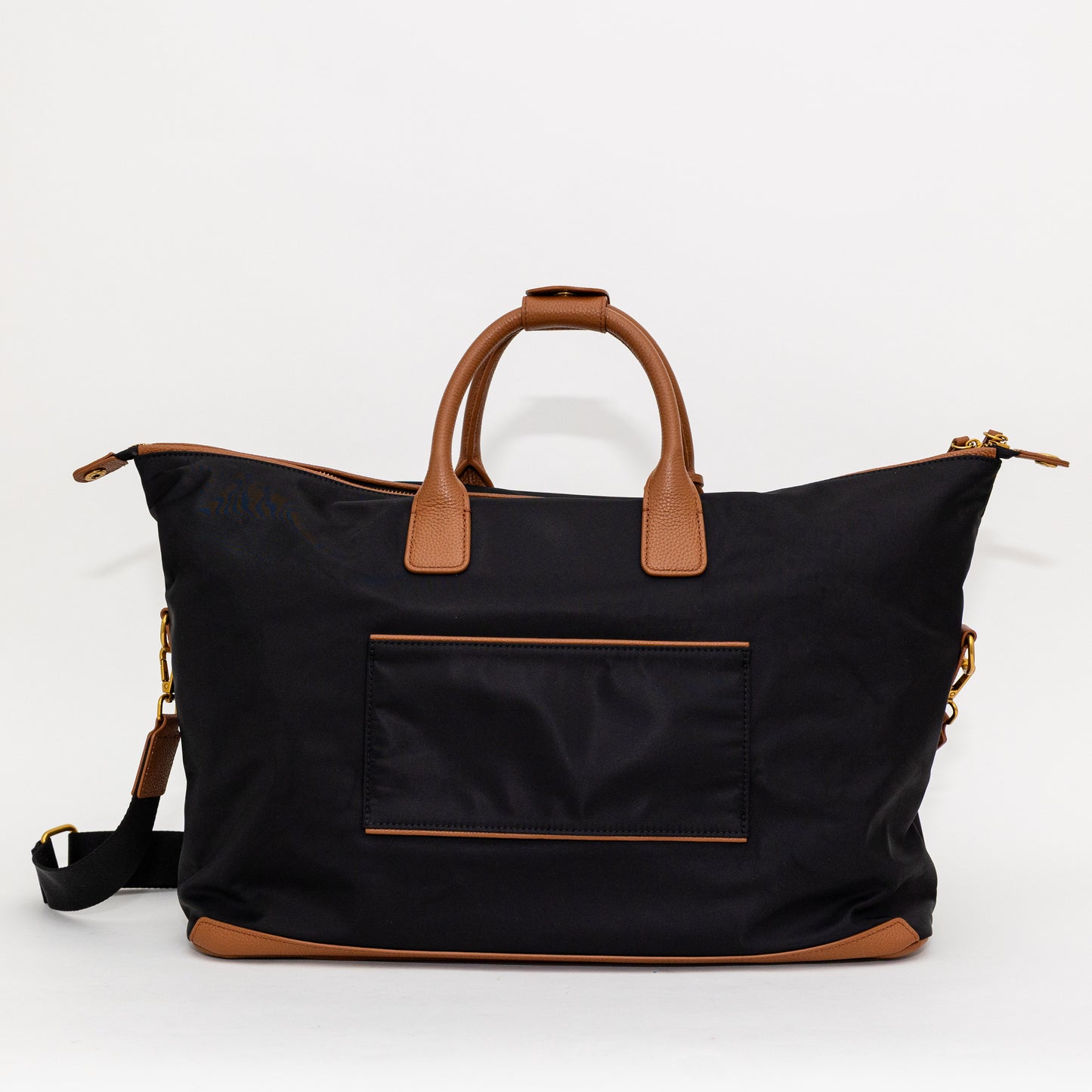 Black carry on bag with brown handles and accents on a white background