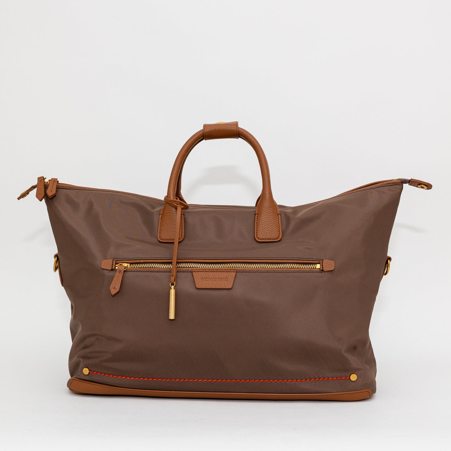 Brown carry on bag with leather handles and trim on a white background