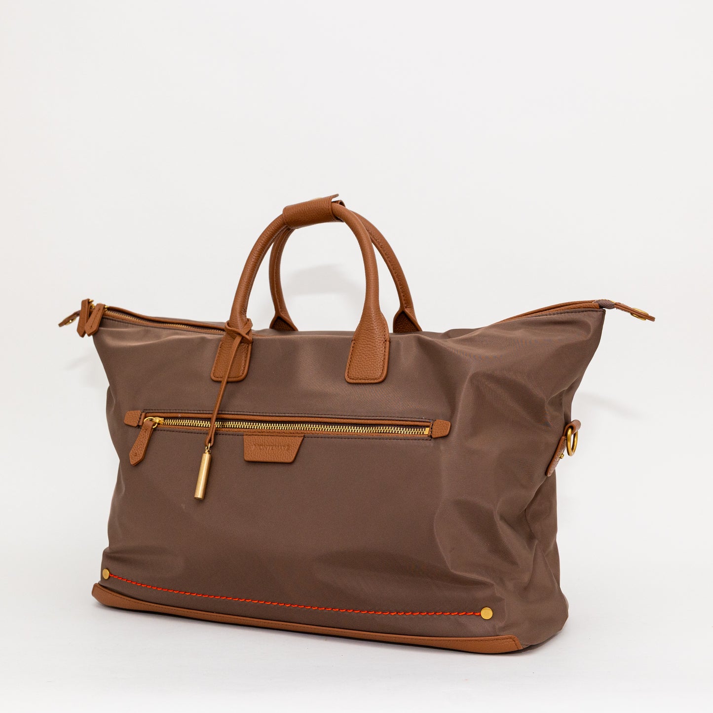 Brown carry on bag with leather accents on a white background