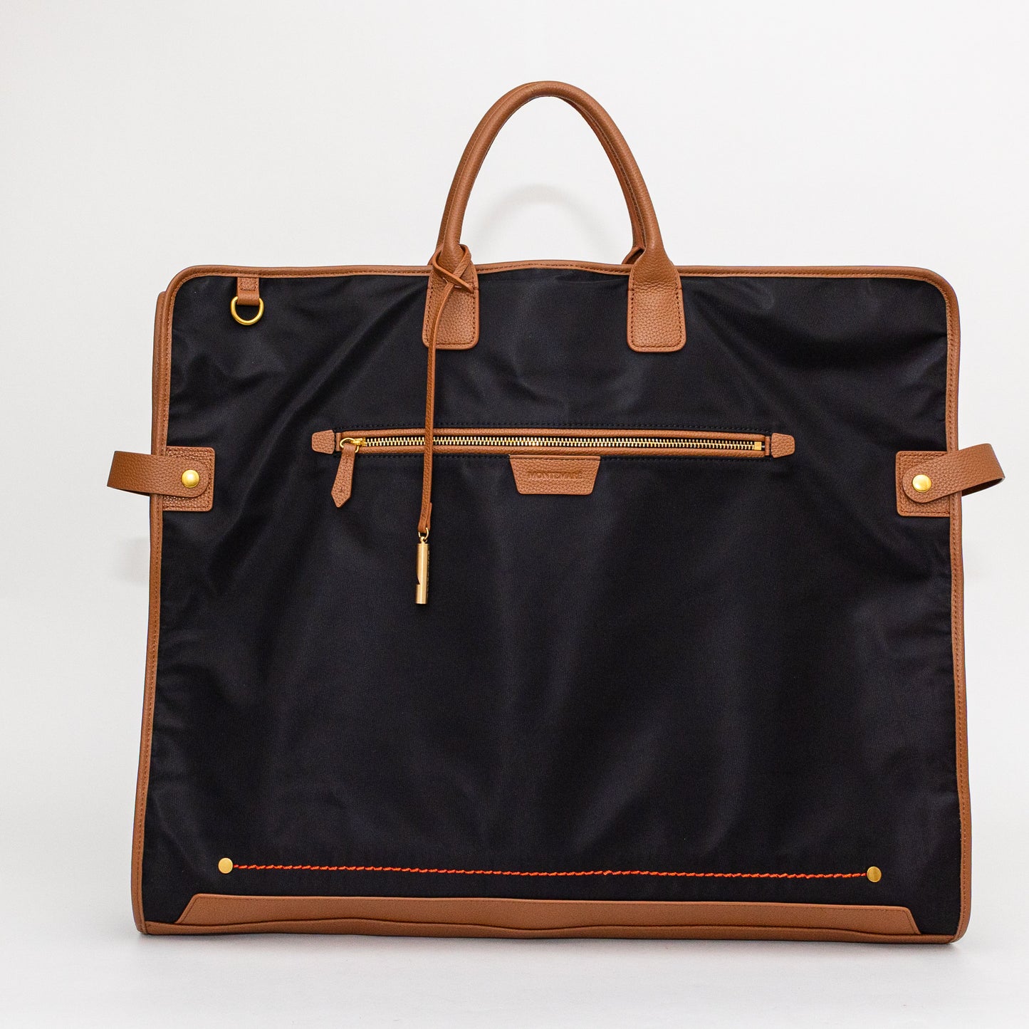 Black garment bag with brown leather accents on a white background