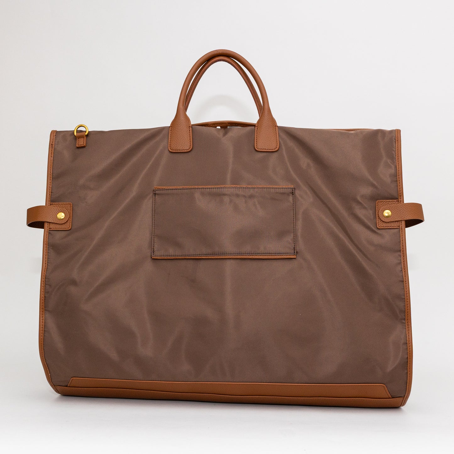 Brown garment bag with leather handles and trim on a white background