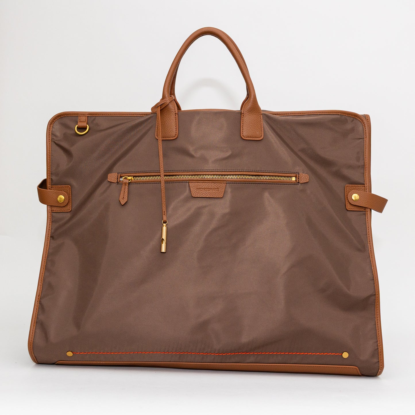Brown garment bag with leather handles and trim on a white background