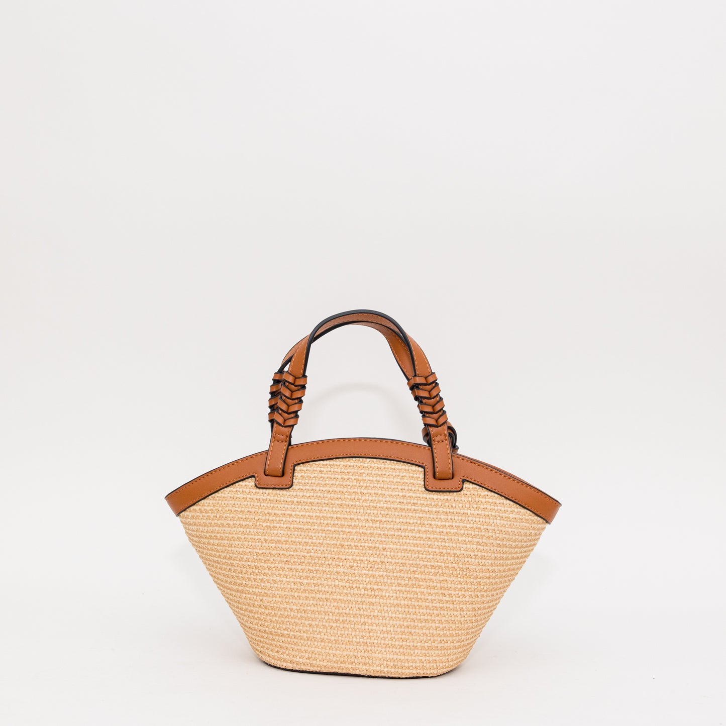 Woven handbag with cognac leather handles on a white background