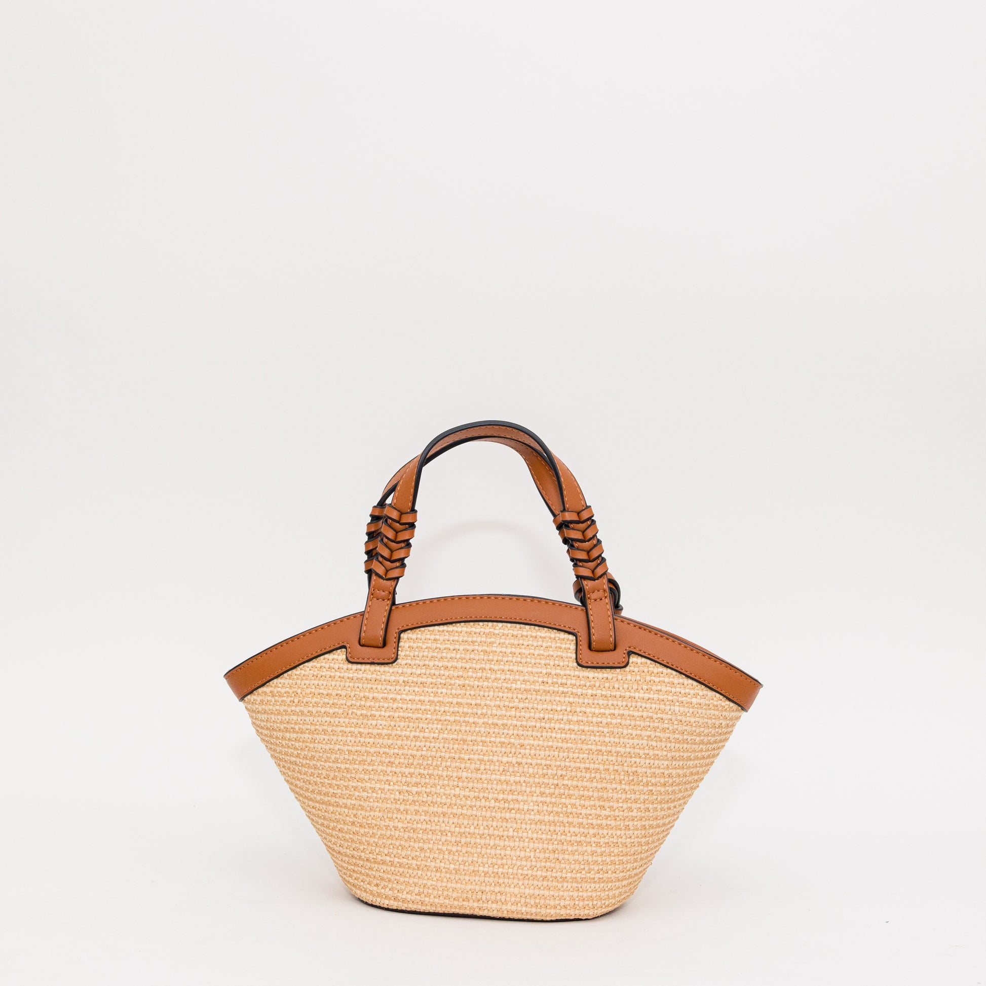 Woven handbag with cognac leather handles on a white background