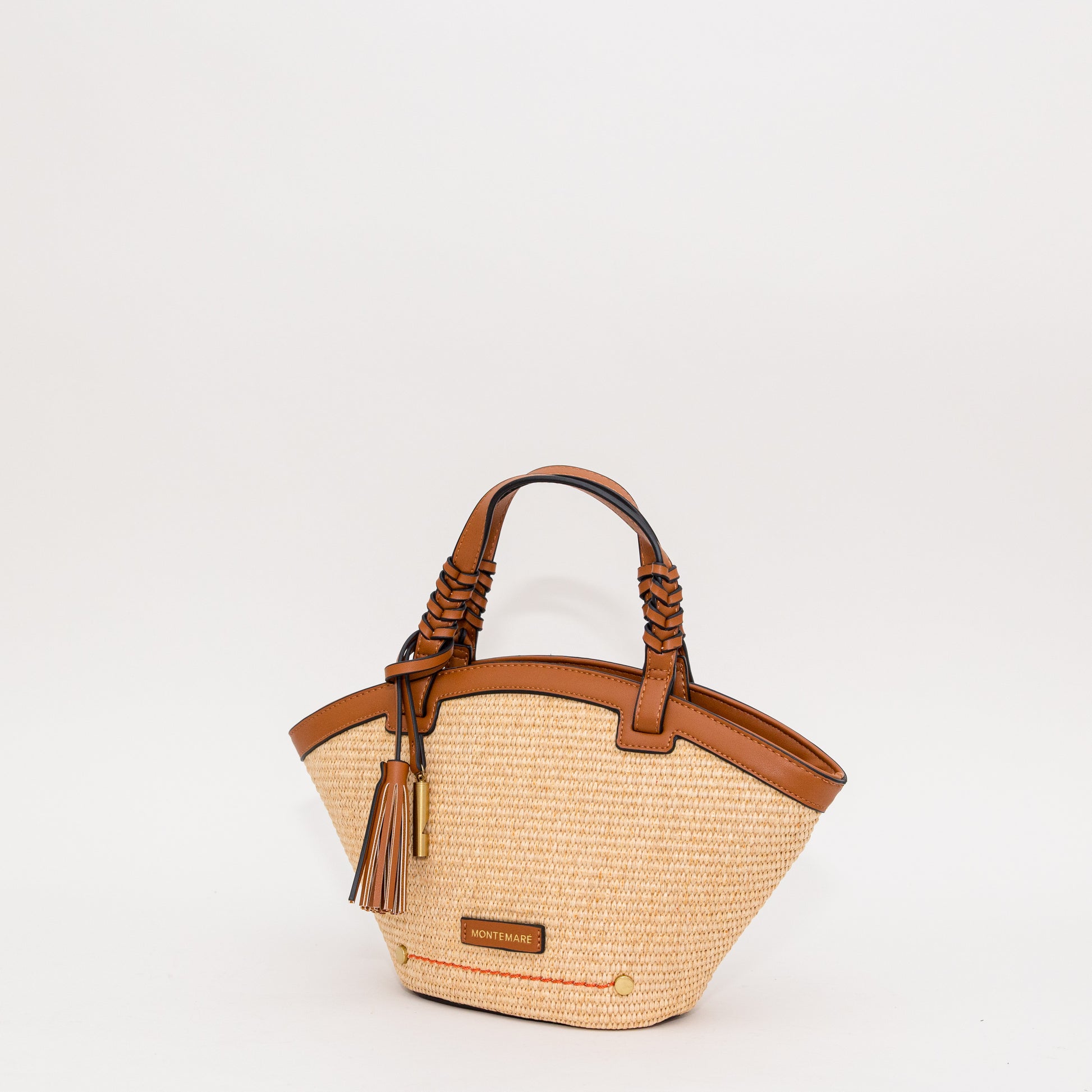 Woven handbag with cognac leather accents on a white background