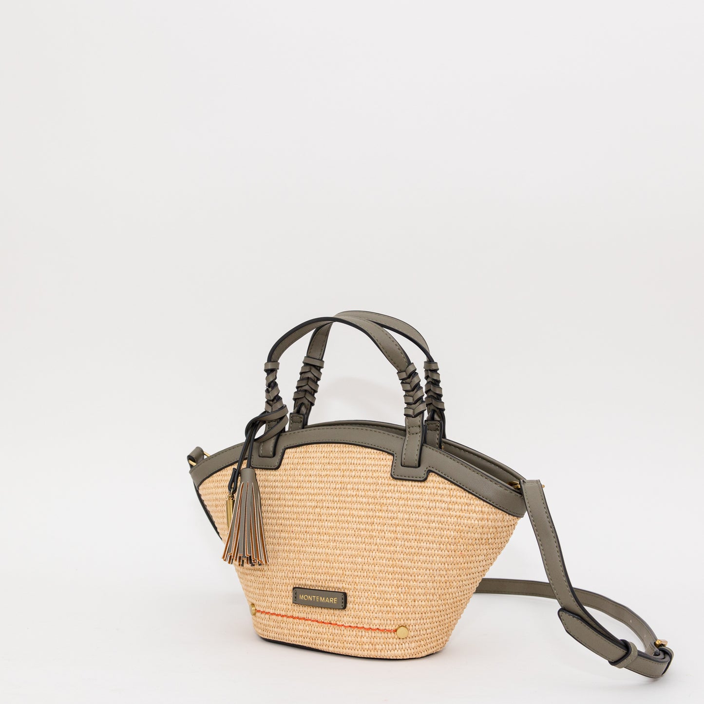 Woven handbag with leather accents on a white background