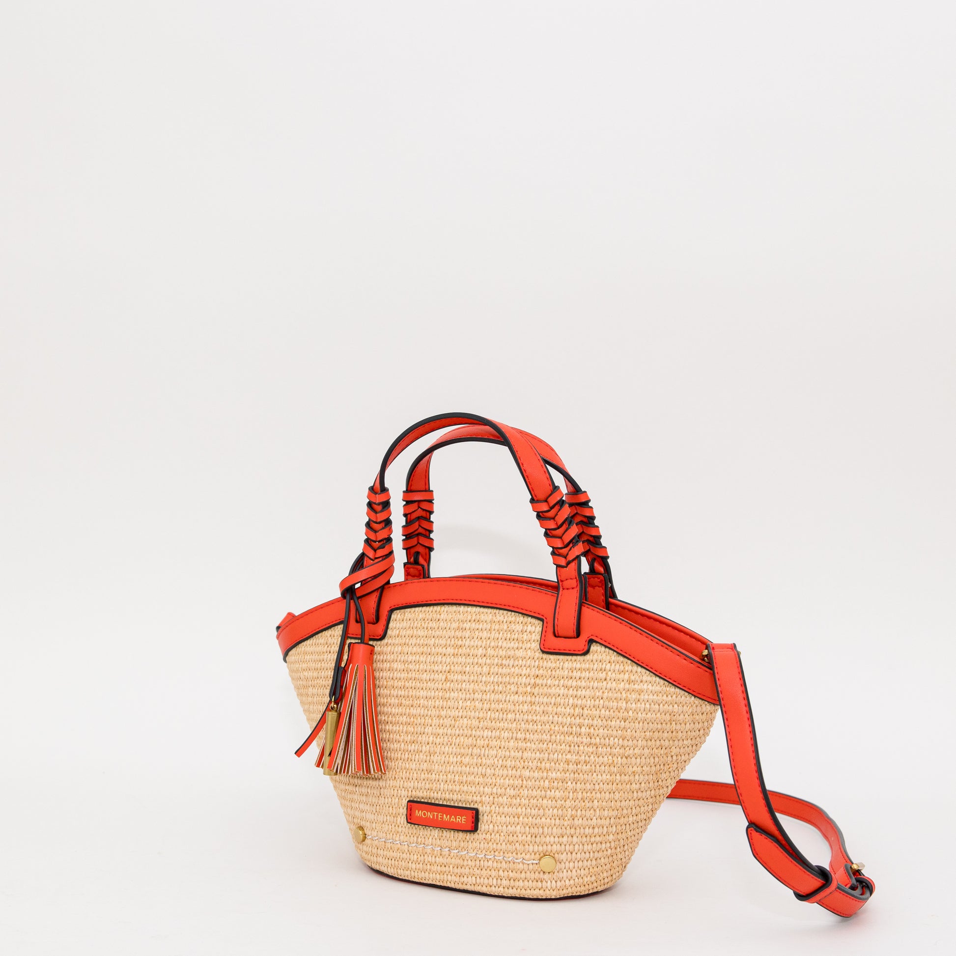 Woven handbag with orange accents on a white background