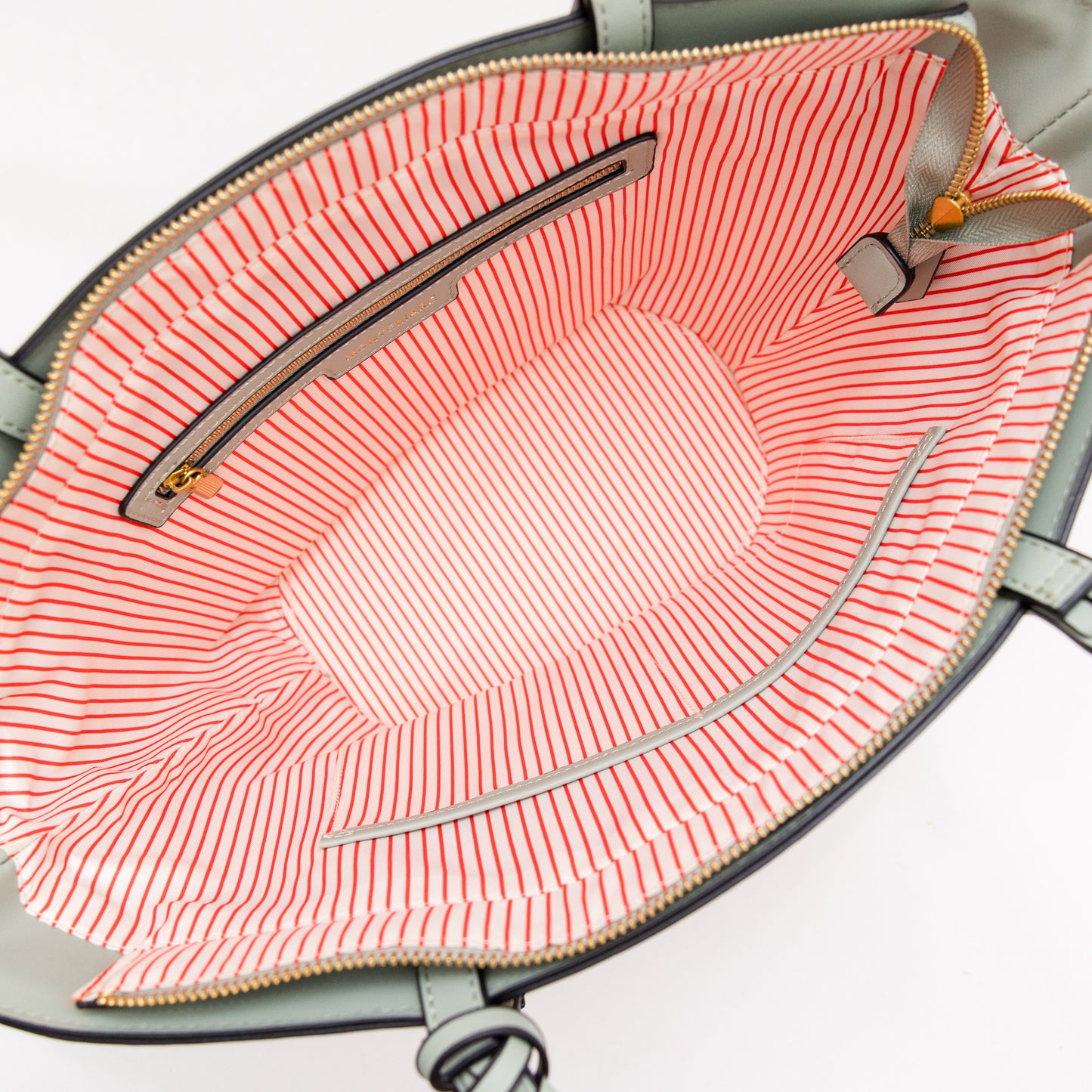 Interior of a woven bag with blue leather accent on a white background