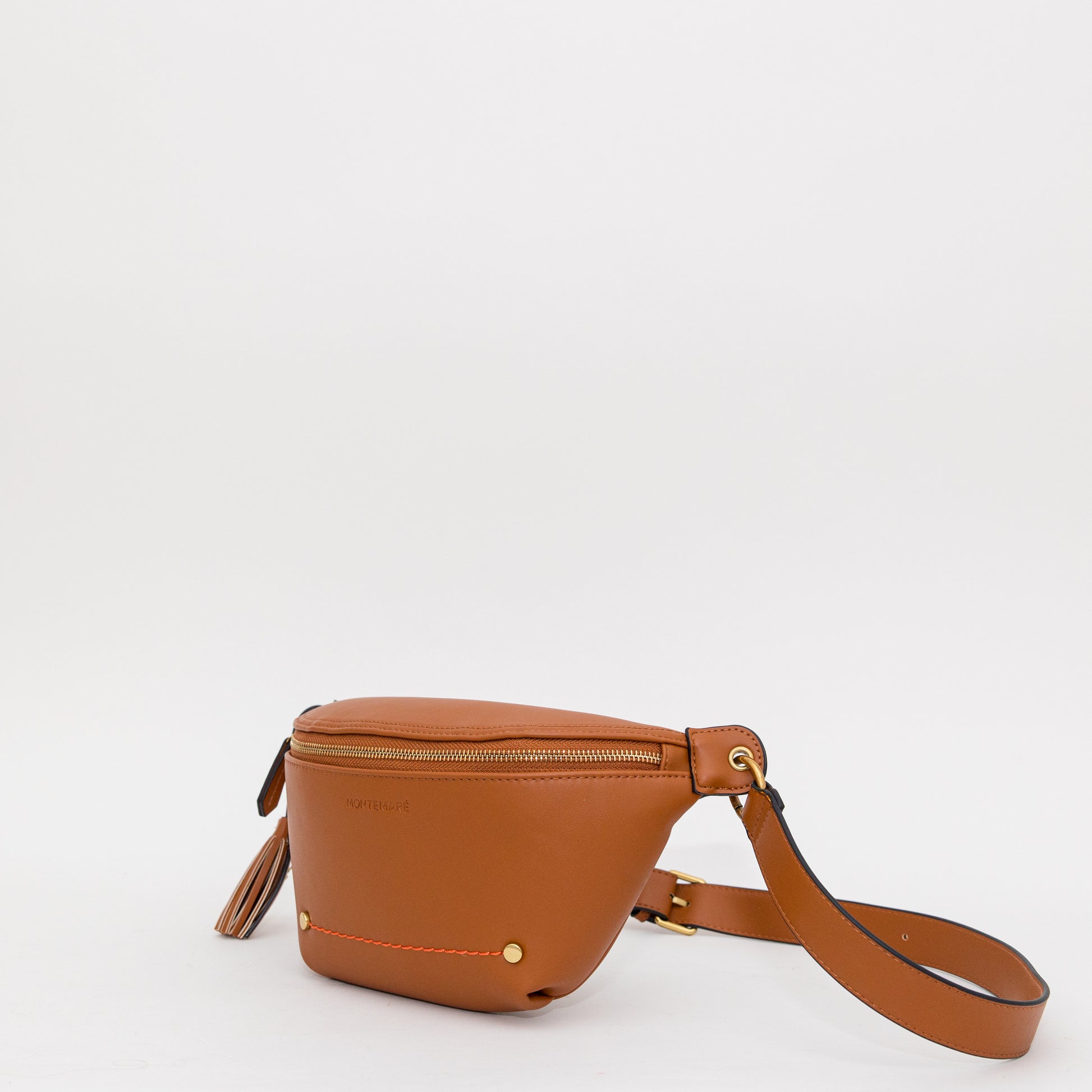 Brown vegan leather sling bag on a white background