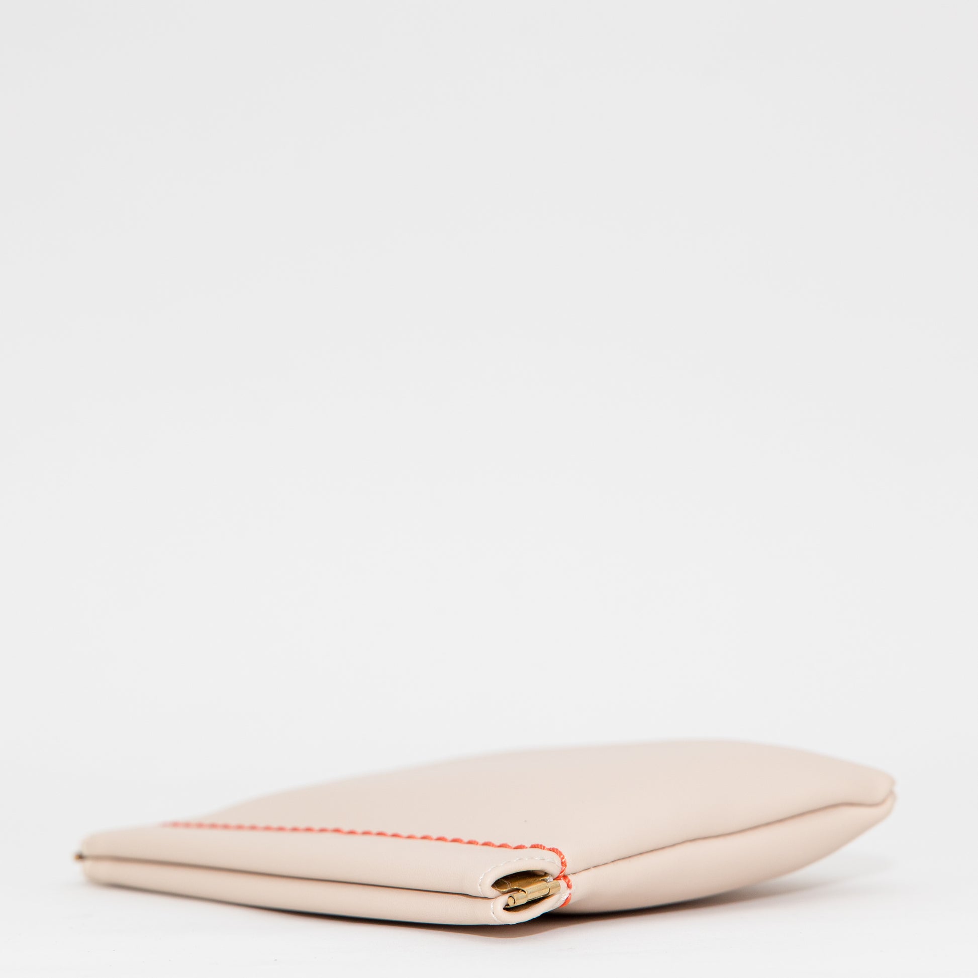 Beige square pouch with gold clasp on a white background