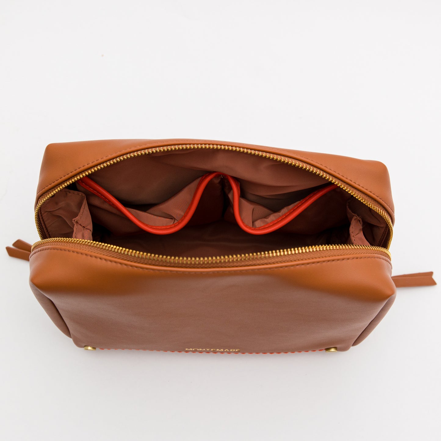 Brown leather toiletry bag with open top on a white background