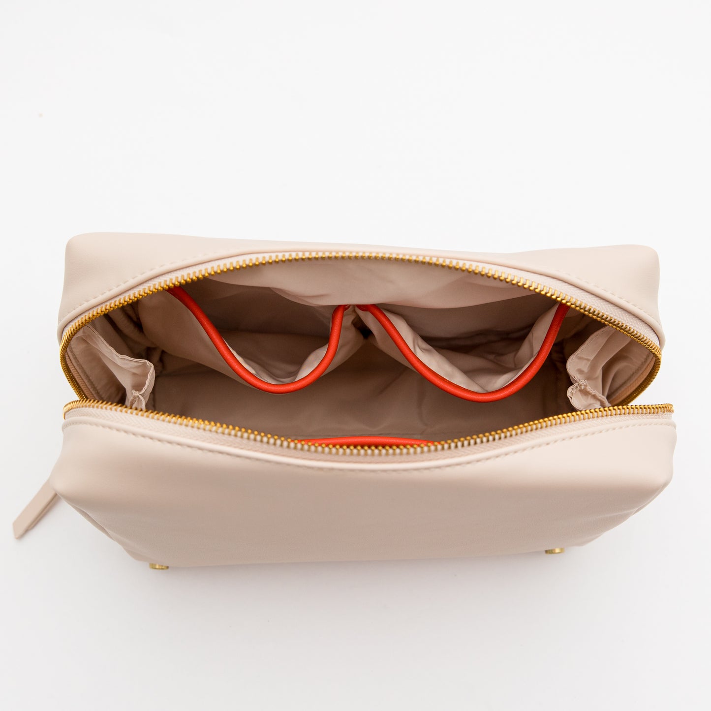 Beige toiletry bag with orange interior lining on a white background
