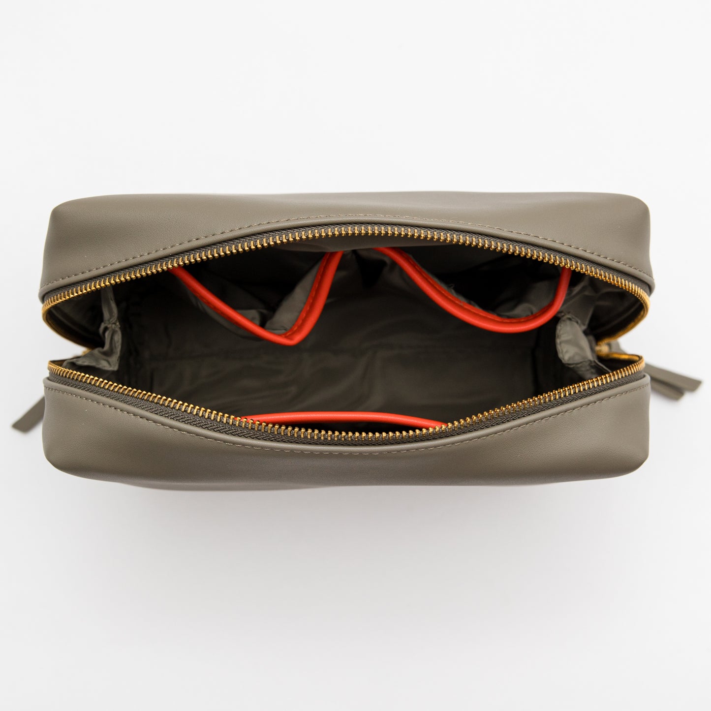 Open gray leather bag with orange interior lining on a white background