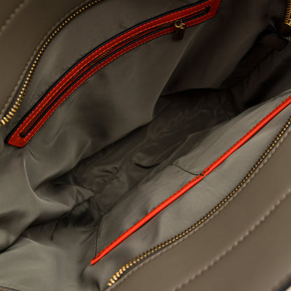 Close-up of an olive green tote bag with orange zipper details