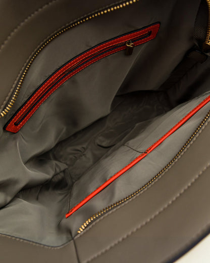 Close-up of an olive green tote bag with orange zipper details