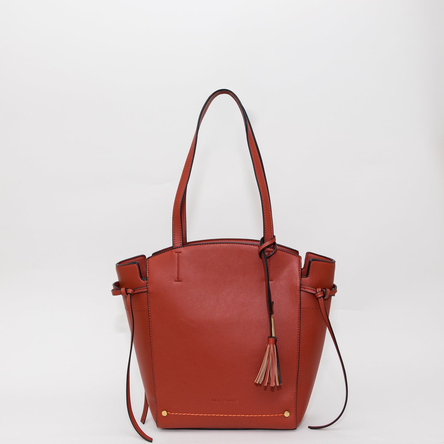Terracotta leather handbag with a tassel on a white background