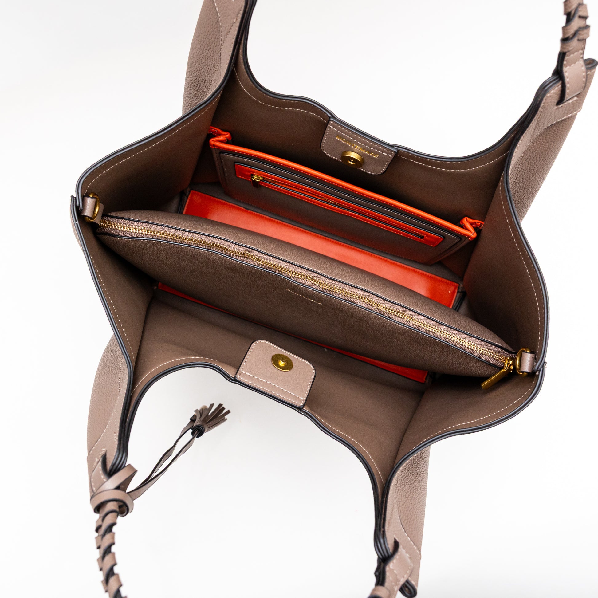 Open brown handbag with red interior on a white background