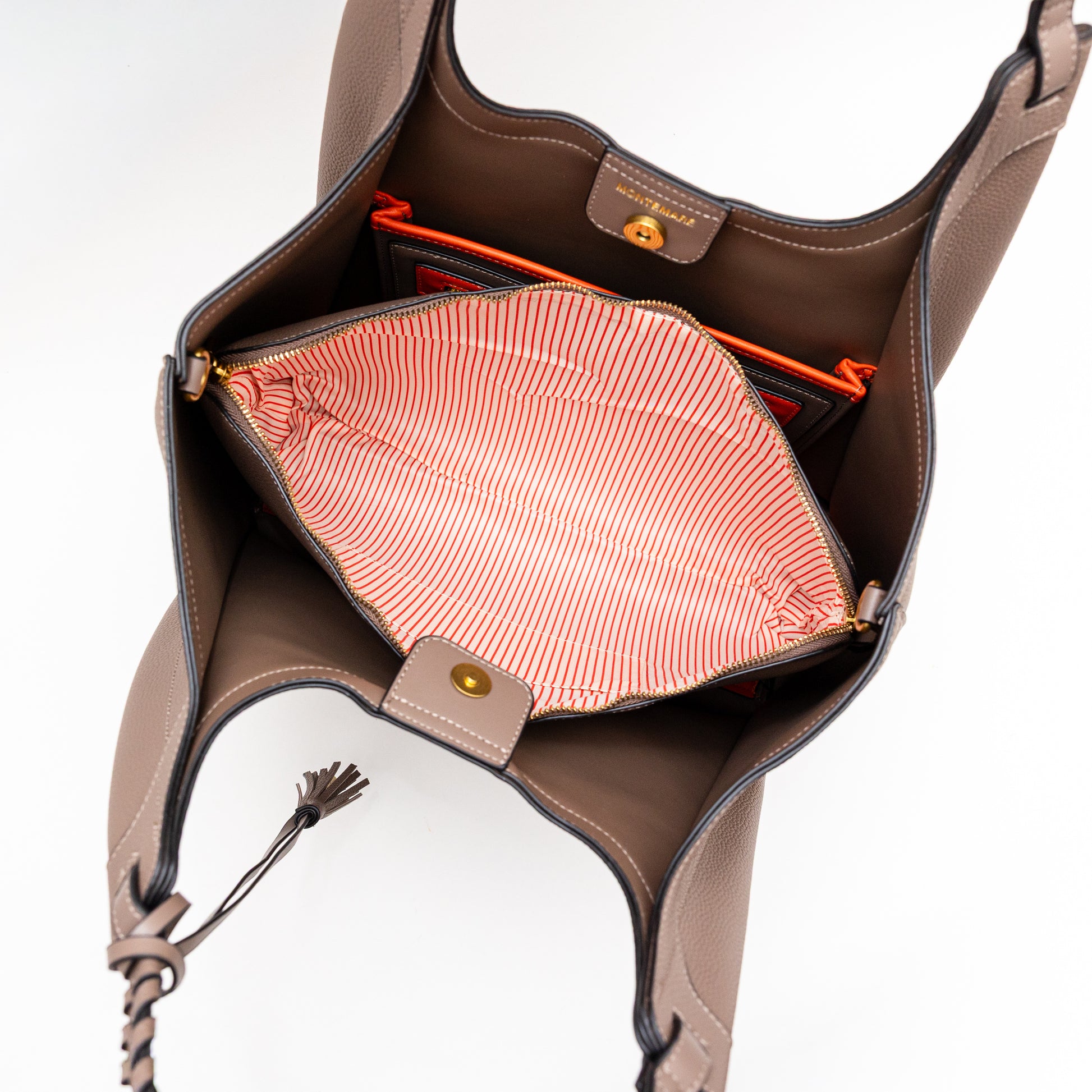 Brown leather handbag with open front, showing pink interior lining.