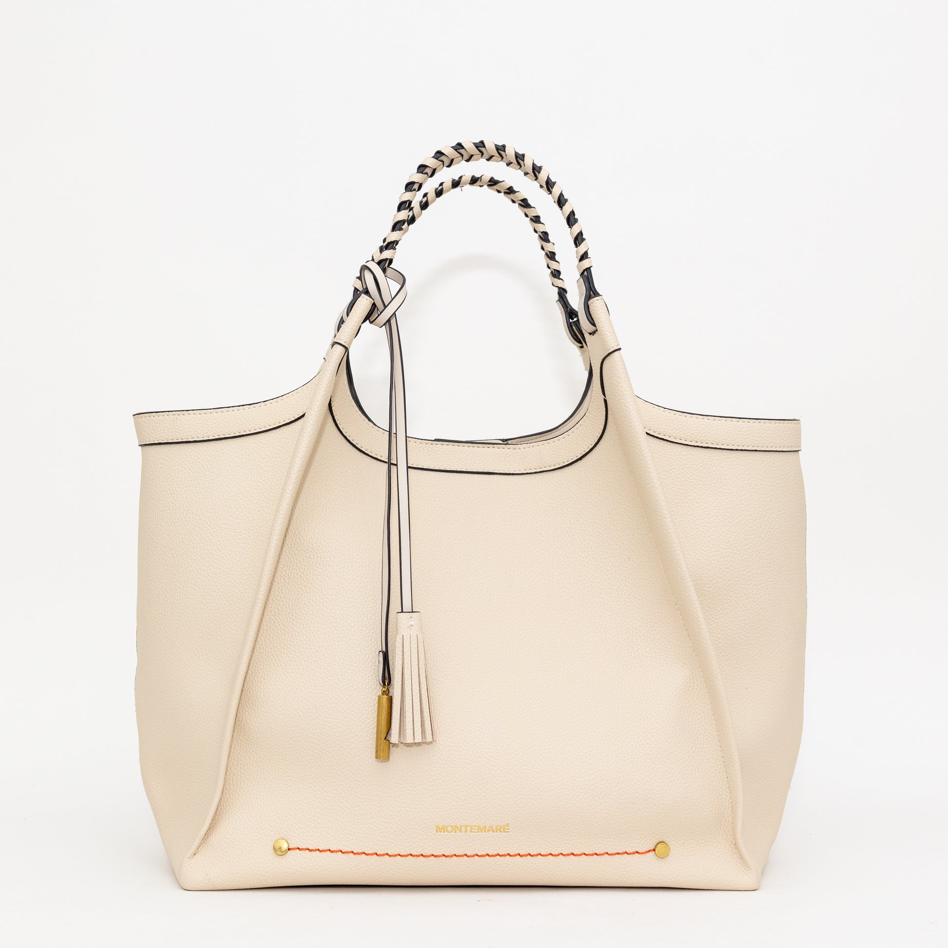 Cream handbag with decorative handle and tassel on a white background