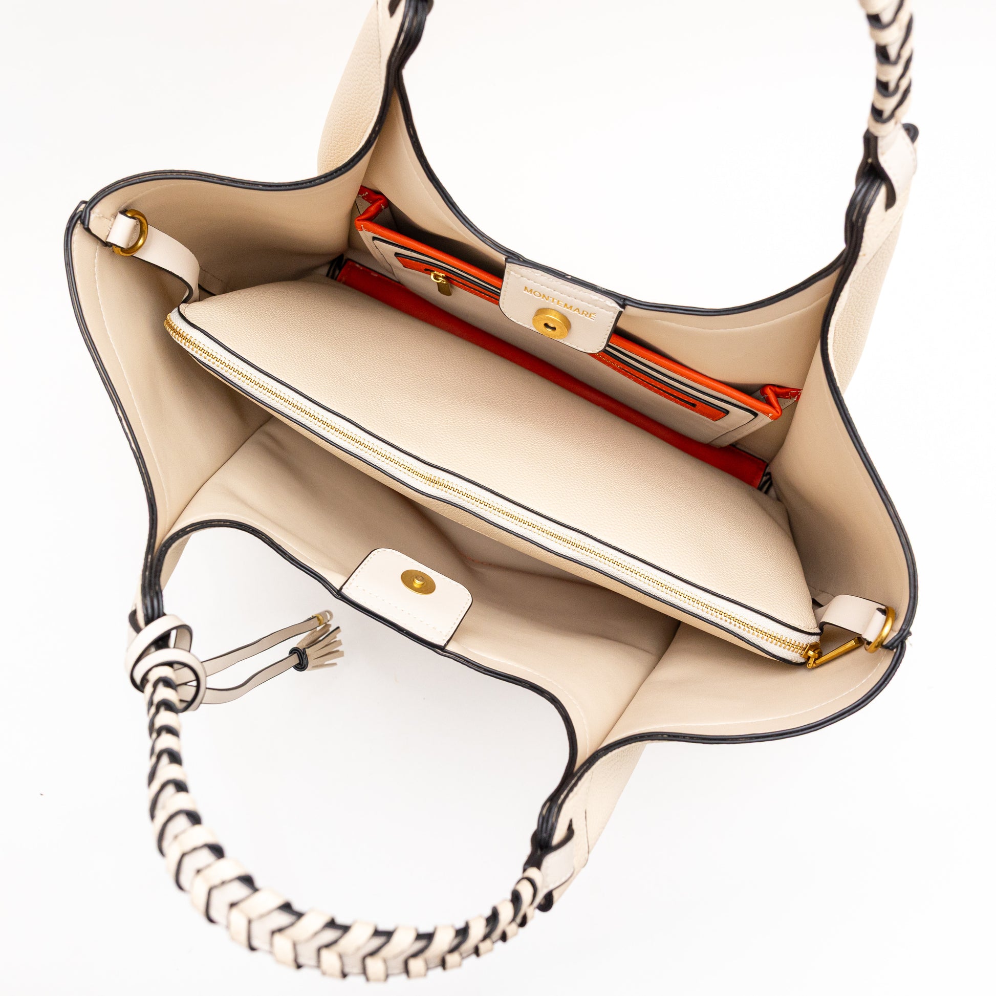 Cream handbag with black accents on a white background