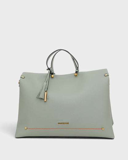 Light blue handbag with gold accents on a white background