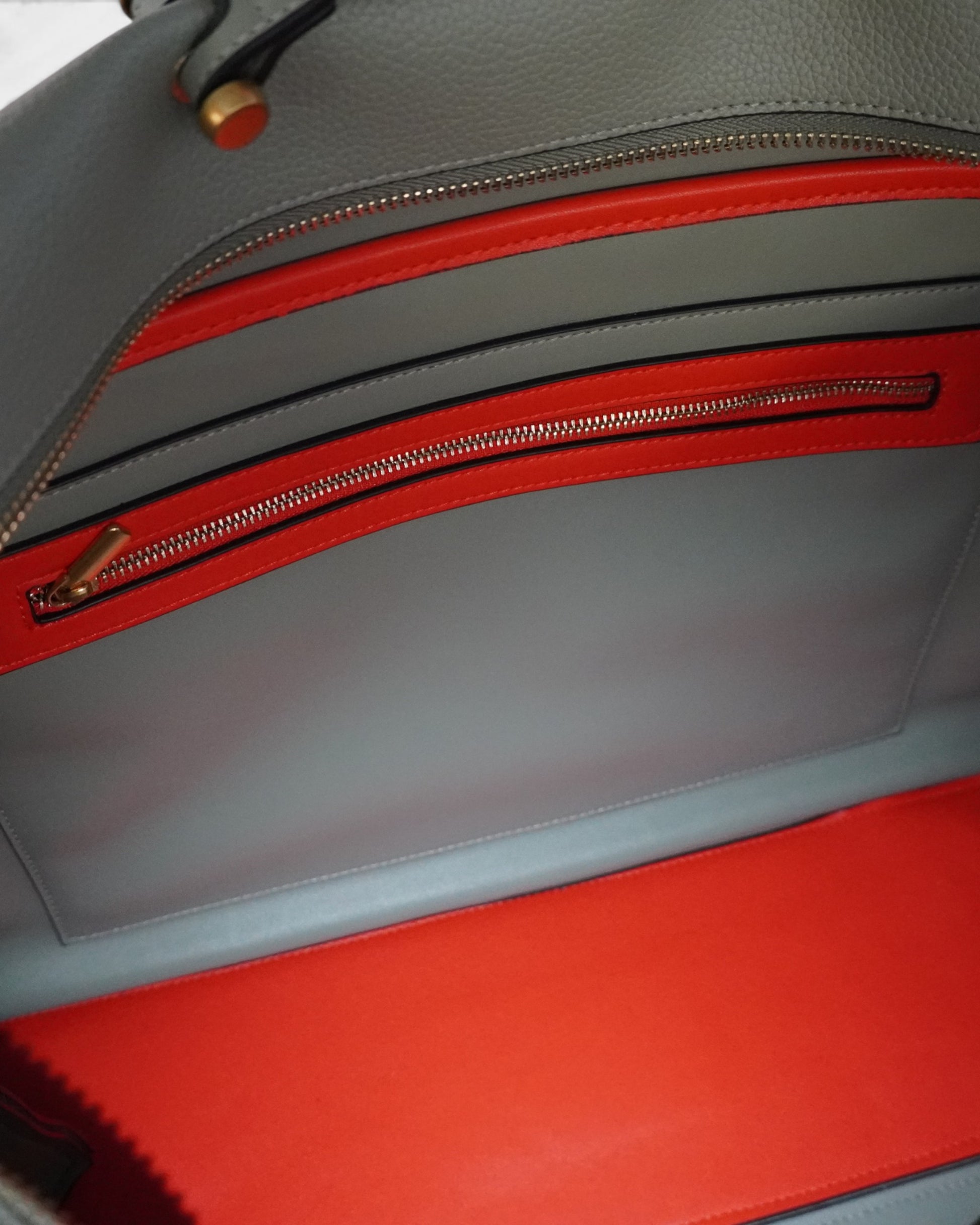 Close up shot of a light blue bag with orange interior linings