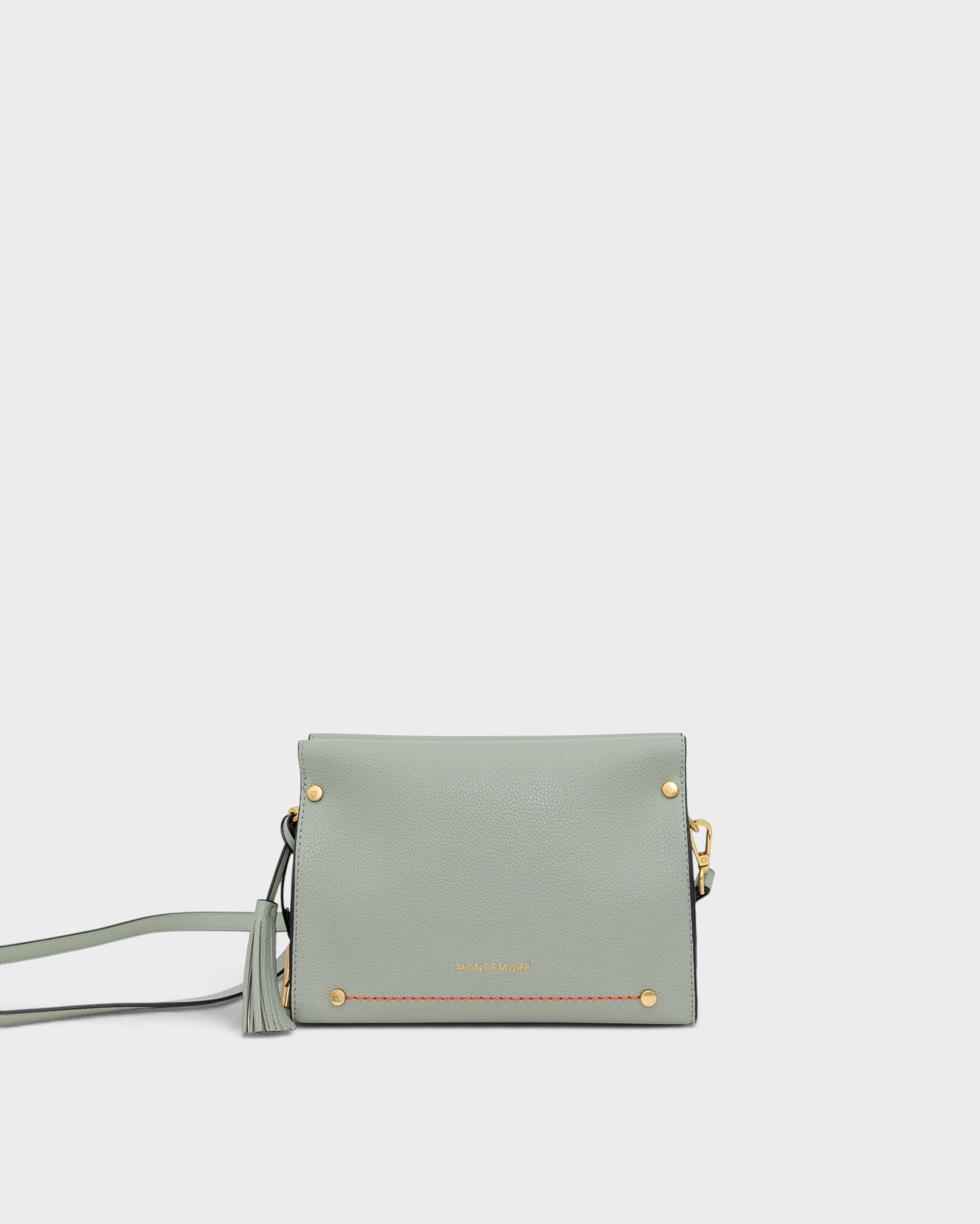 Light blue handbag with gold accents on a white background