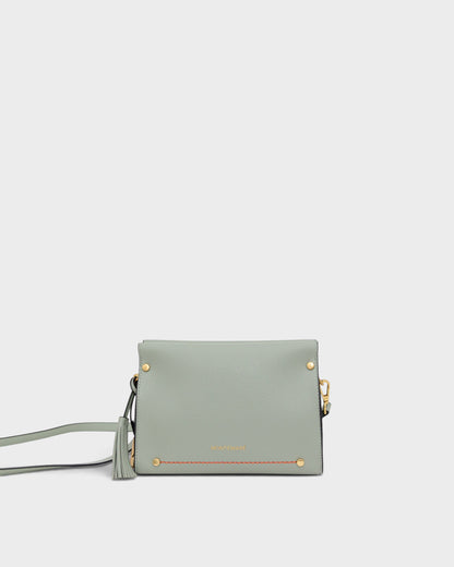 Light blue handbag with gold accents on a white background
