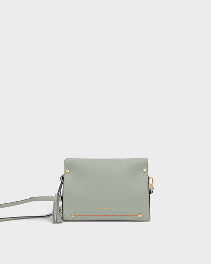 Light blue handbag with gold accents on a white background