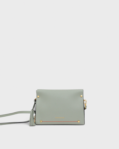 Light blue handbag with gold accents on a white background