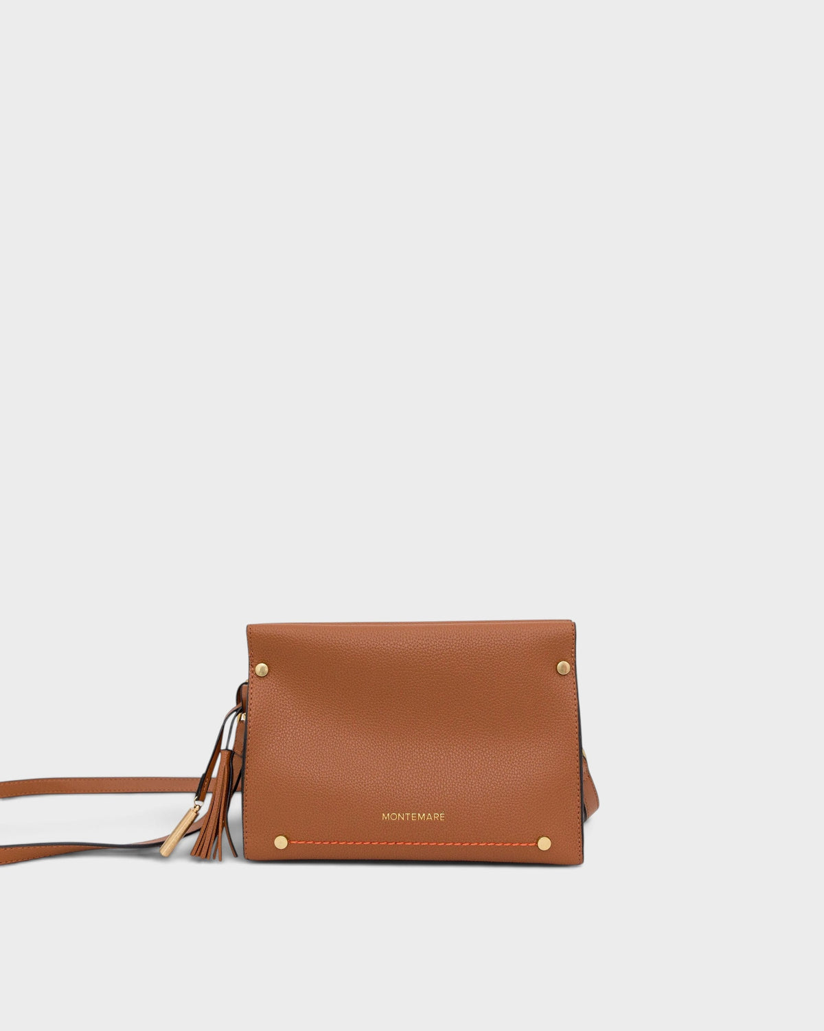 Brown leather handbag with gold accents on a light gray background