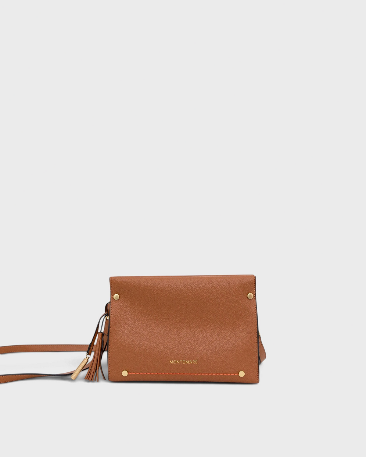 Brown leather handbag with gold accents on a light gray background