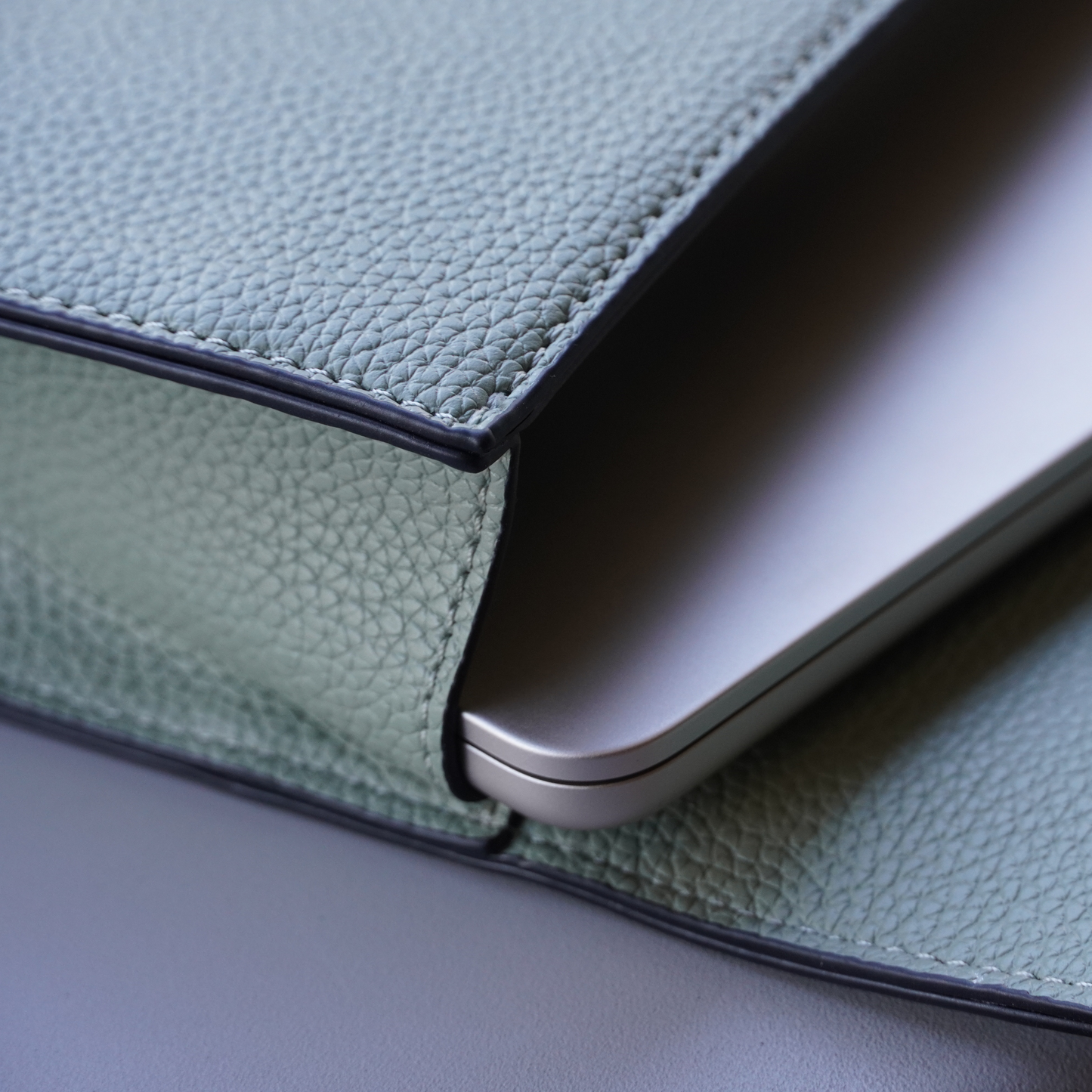 Detailed shot of Montemare Vienna Laptop Case in Blake's Blue colorway with a laptop inside it
