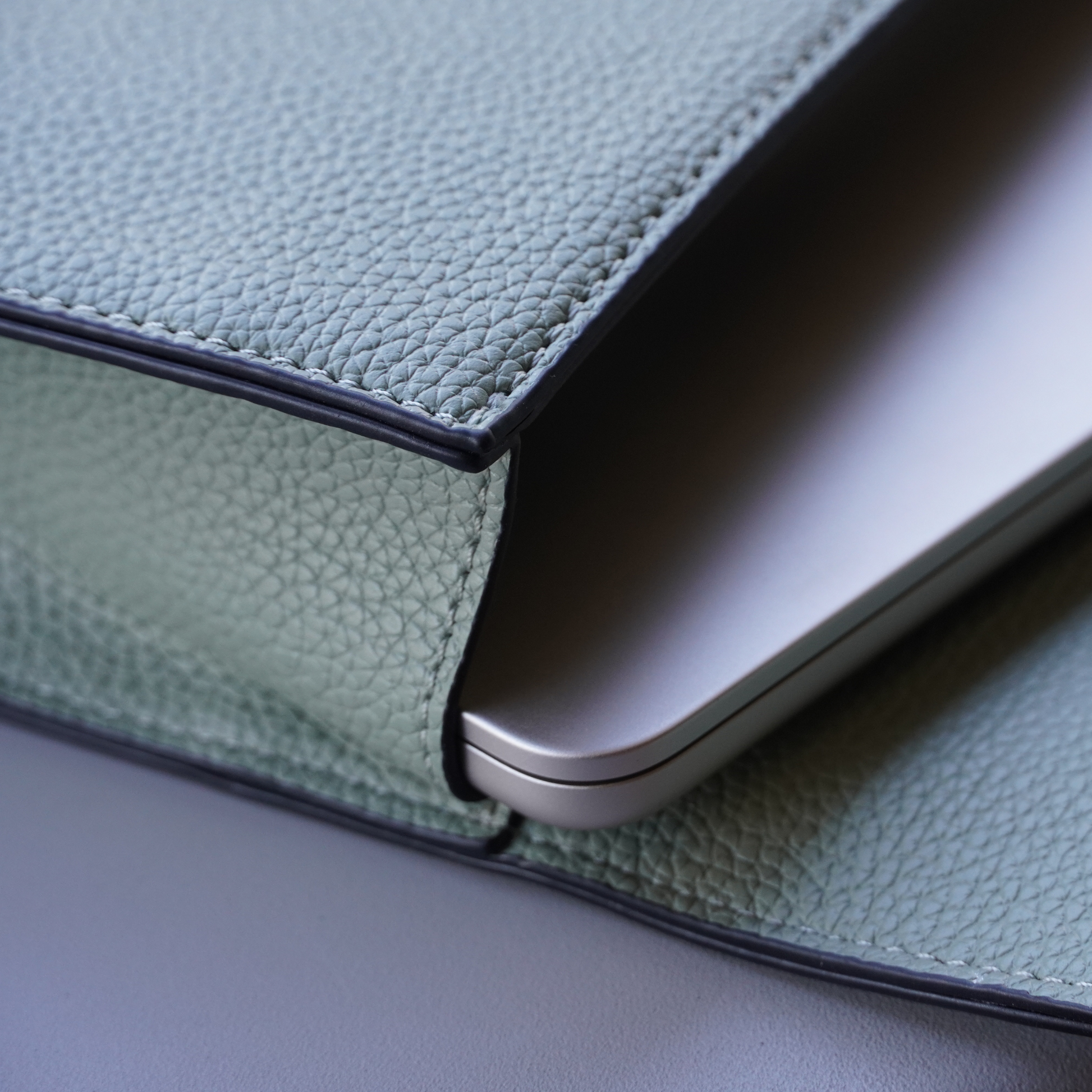 Detailed shot of Montemare Vienna Laptop Case in Blake's Blue colorway with a laptop inside it