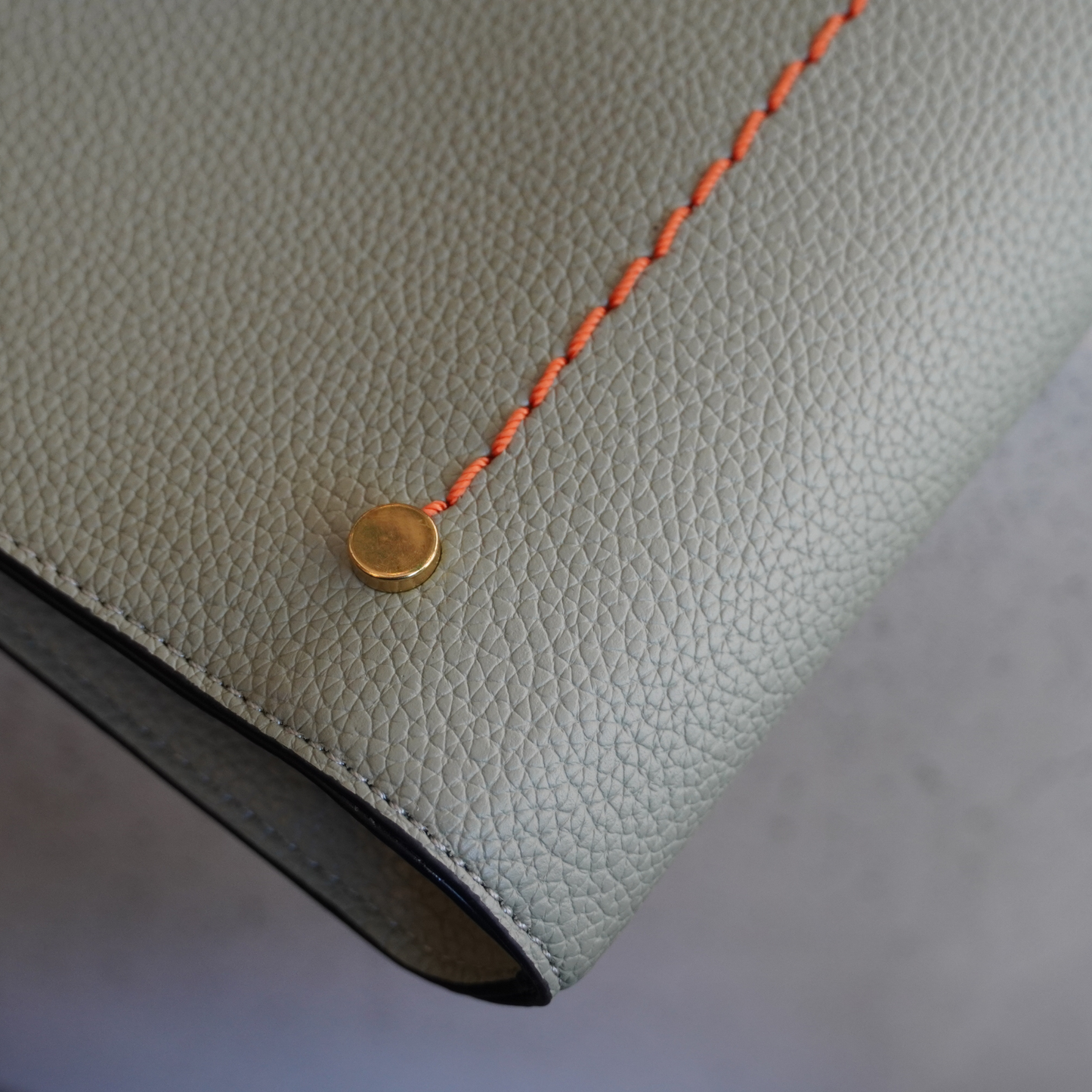 Close up shot of the Montemare Vienna Laptop Case in Blake's Blue colorway highlighting its orange journey line detail