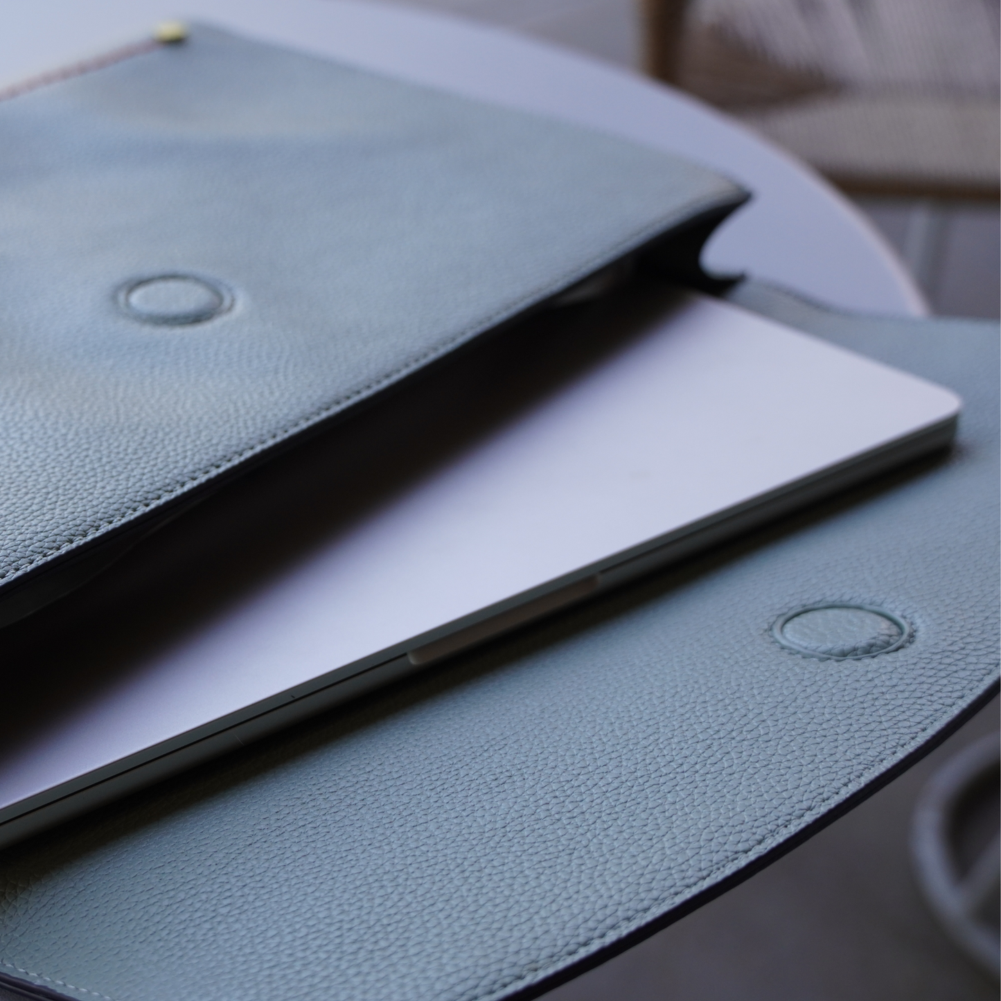 Close up shot of Montemare Vienna Laptop Case in Blake's Blue colorway with a laptop inside it