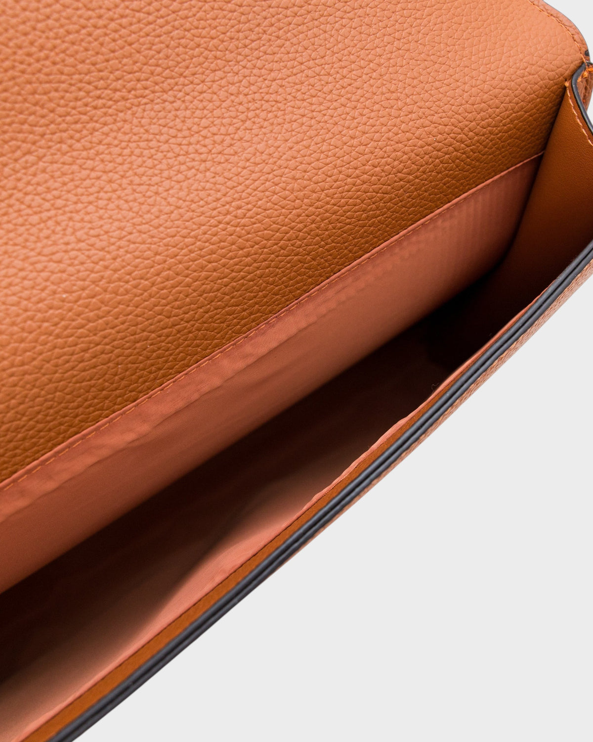 Close-up of a brown leather bag on a light background