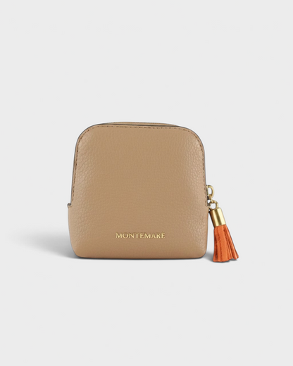 Montemaré small beige leather travel jewelry case with a decorative orange tassel zipper pull