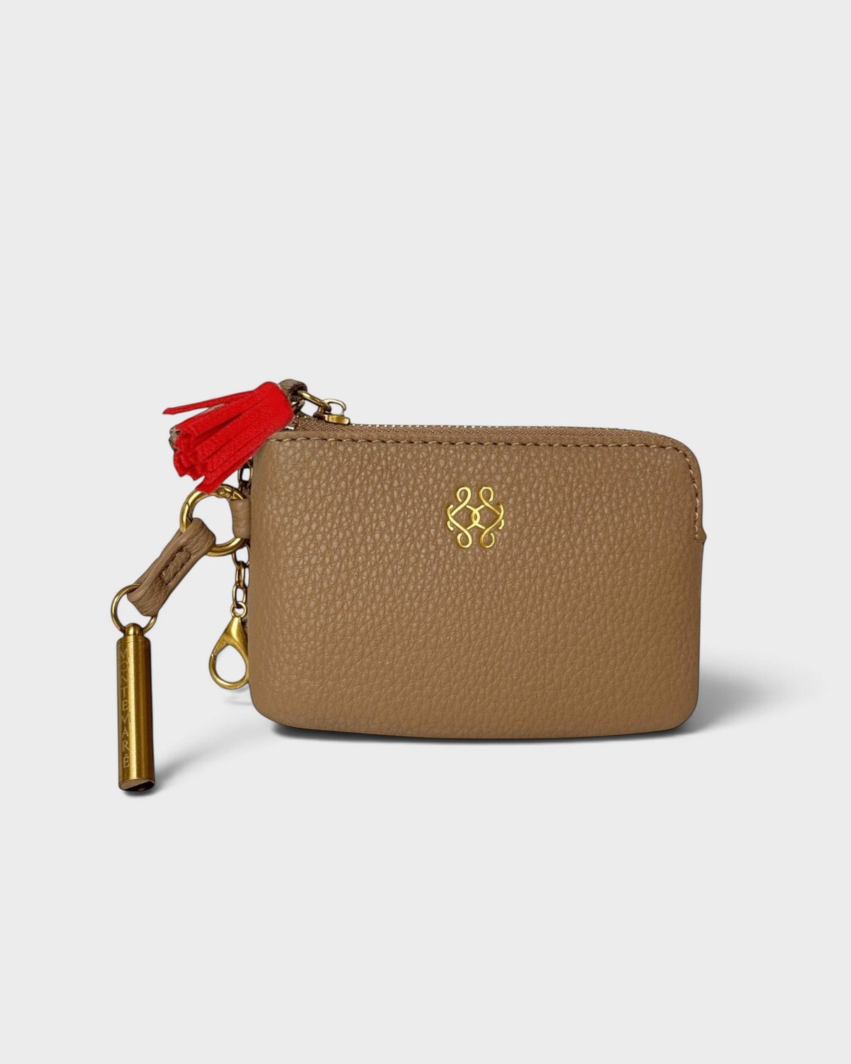 Montemaré beige vegan leather RFID card case with a red tassel, gold hardware, and a removable safety whistle keychain.