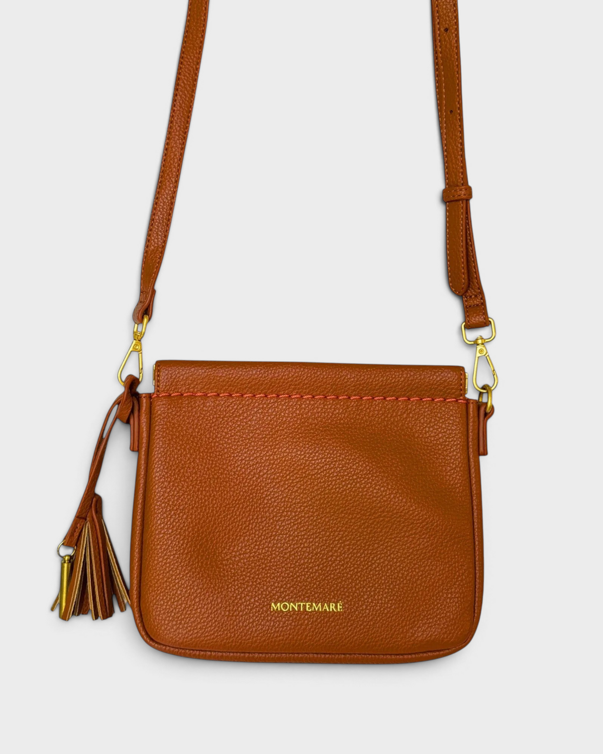 Montemaré brown pebbled leather square crossbody pouch with gold hardware and a decorative side tassel