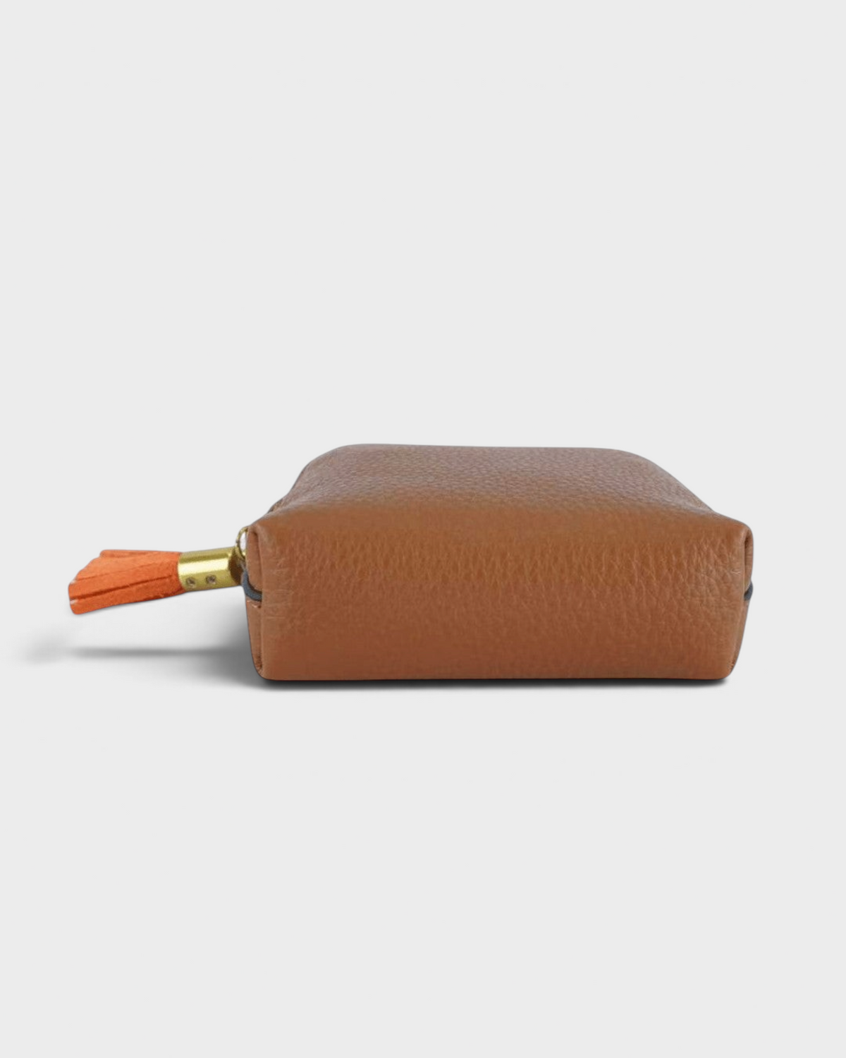 Montemaré small brown leather travel jewelry case with a decorative orange tassel zipper pull