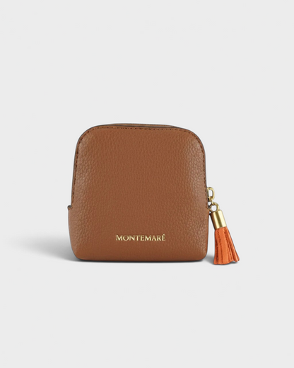 Montemaré small brown pebbled leather travel jewelry case with a gold zipper and matching tassel charm