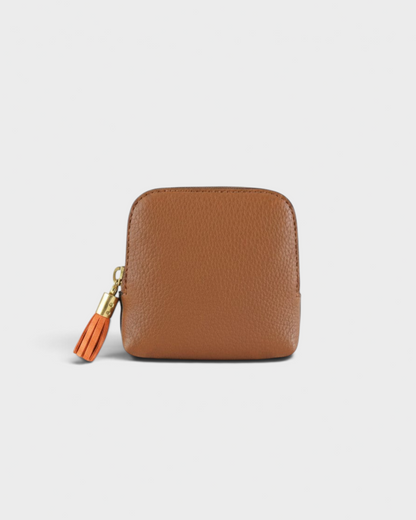 Montemaré small brown leather travel jewelry case with a decorative orange tassel zipper pull