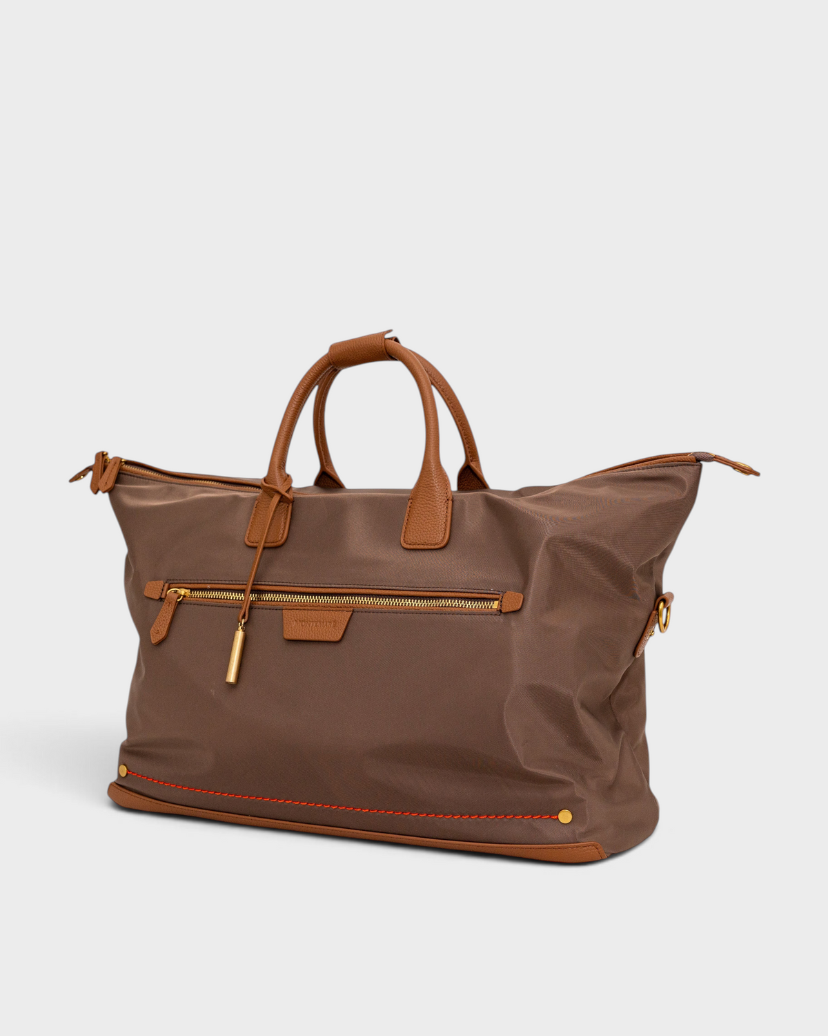 Montemaré brown waterproof nylon weekender bag with genuine leather trim, gold hardware, and front zippered pocket.
