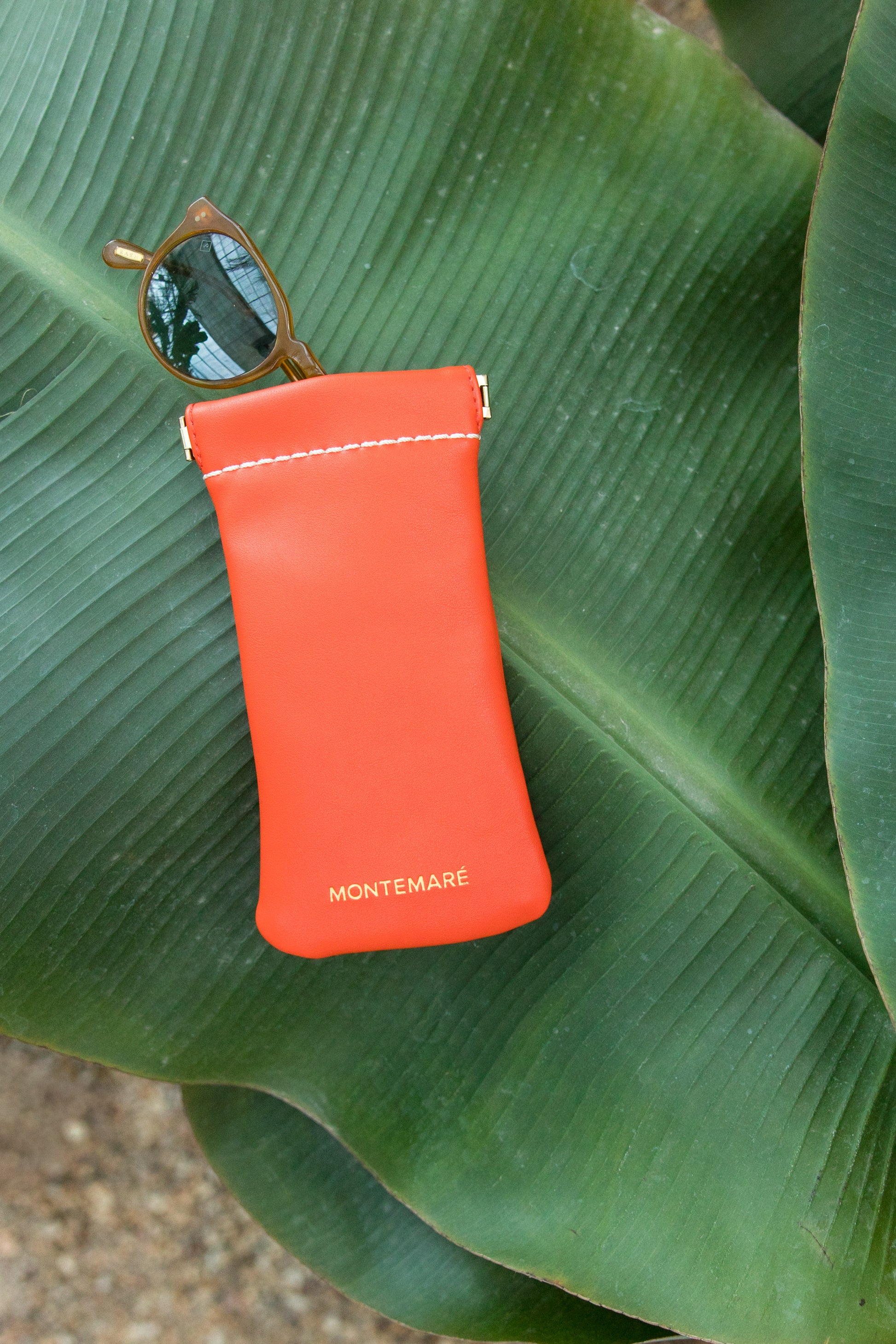 Montemaré Glasses Case in Orange on green banana leaf