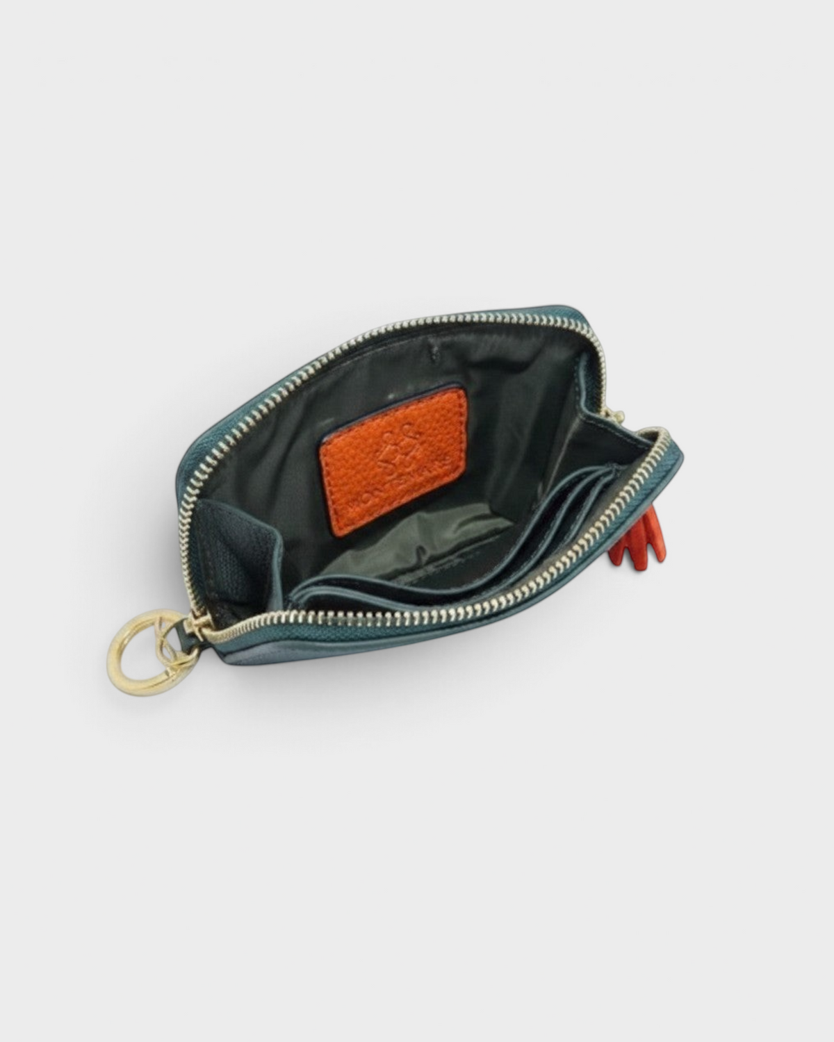 Montemaré RFID-blocking vegan leather card case in green with interior card slots, gold zipper, and orange tassel.