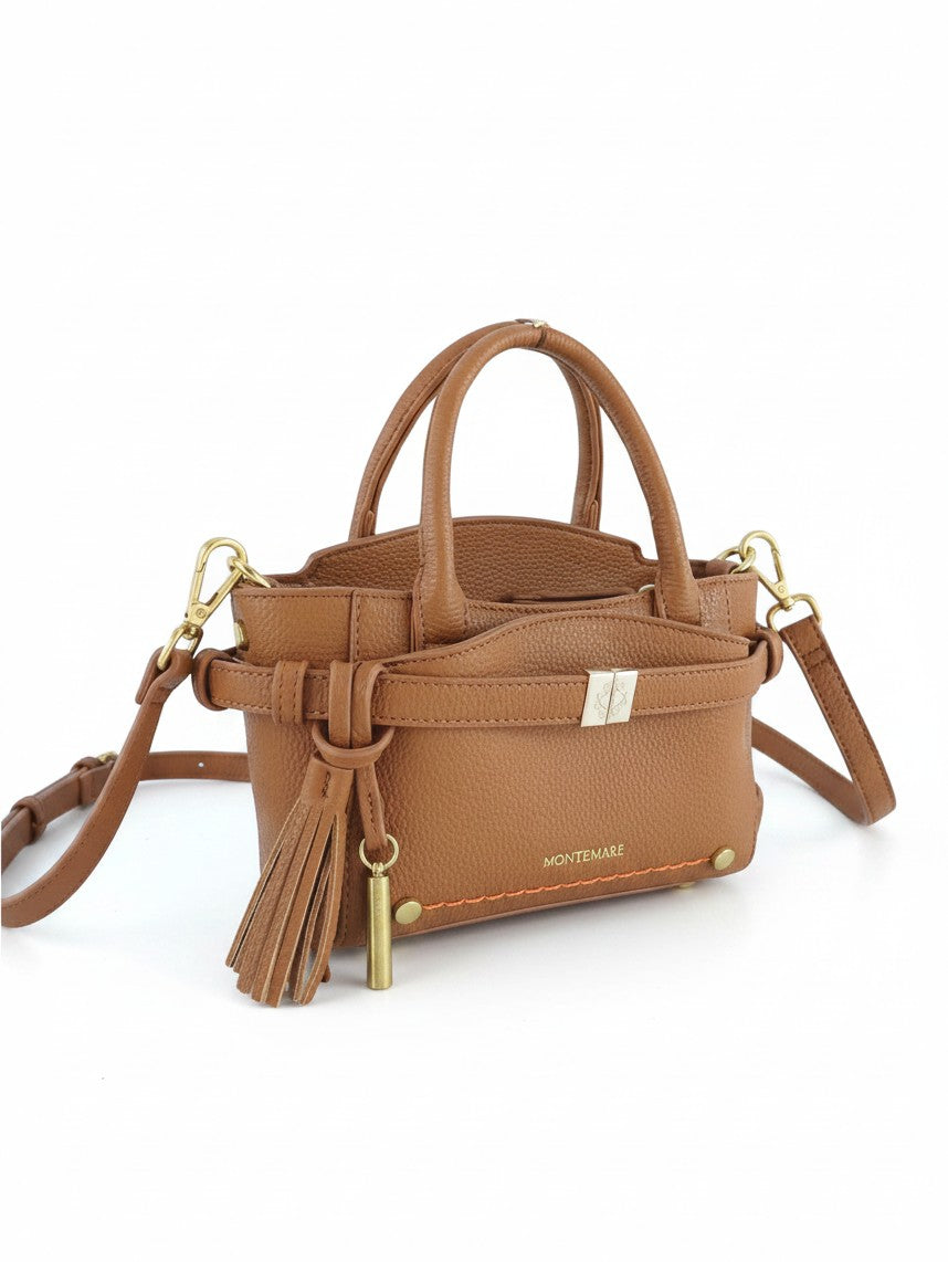 Montemaré Mayfair Mini Crossbody bag in tan pebbled leather with a tassel charm and gold-tone hardware