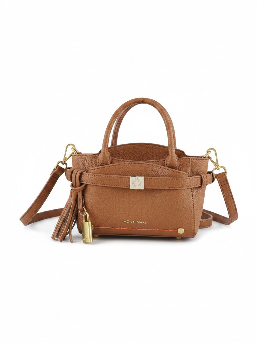 Montemaré Mayfair Mini Crossbody bag in tan pebbled leather with gold hardware, tassel detail, and a small padlock.