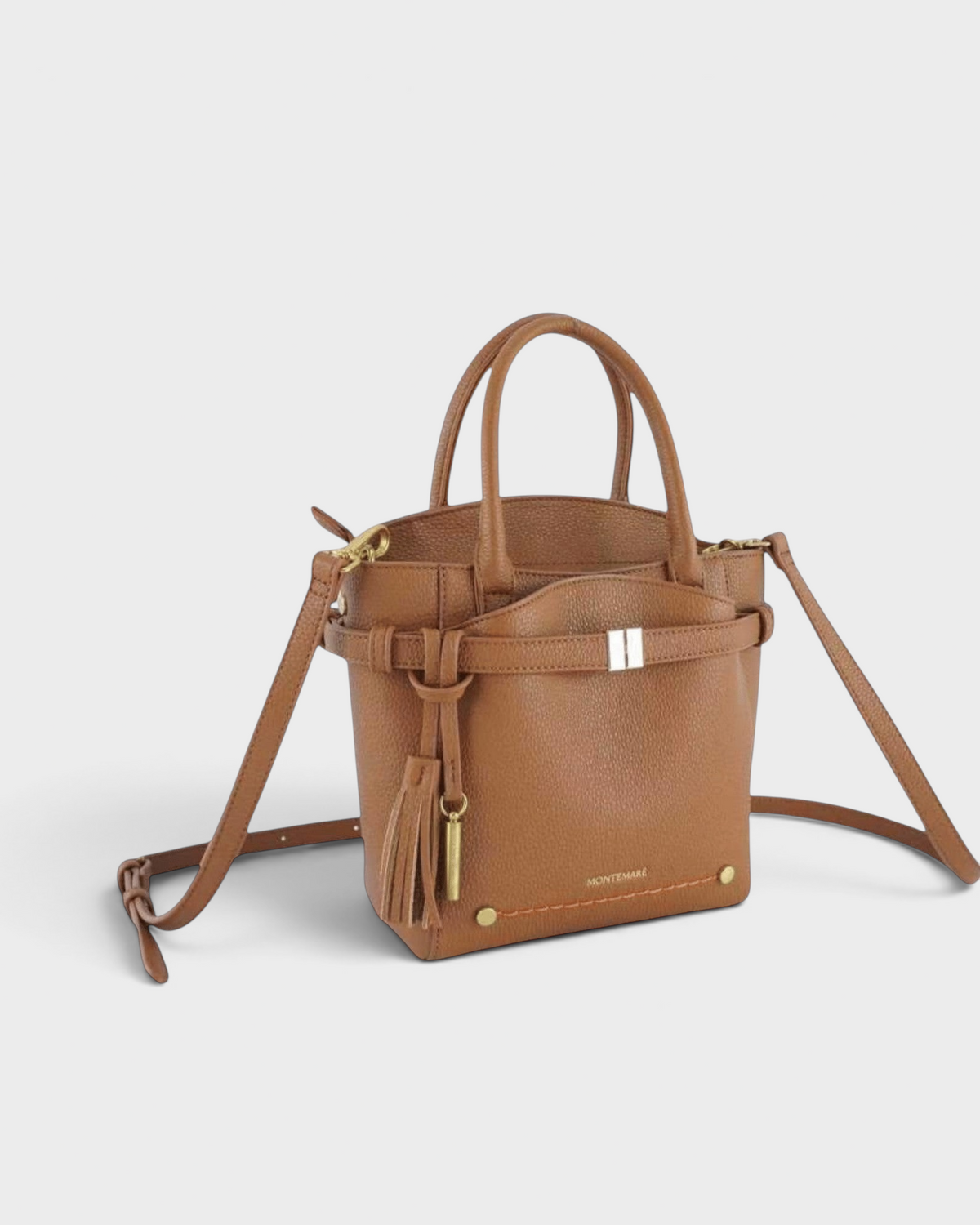 Montemaré Mayfair Tall crossbody bag in tan pebbled leather with top handles, tassel detail, and gold hardware.